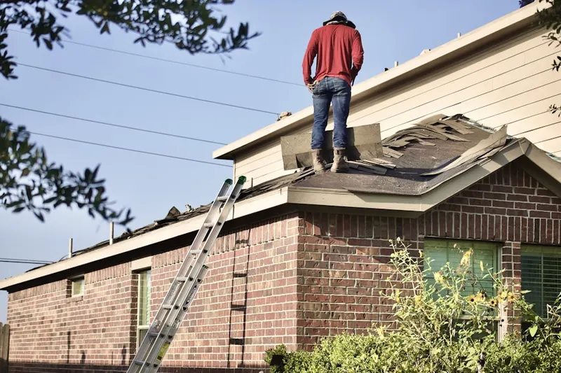 Professional roofer working on a residential roof in Englewood